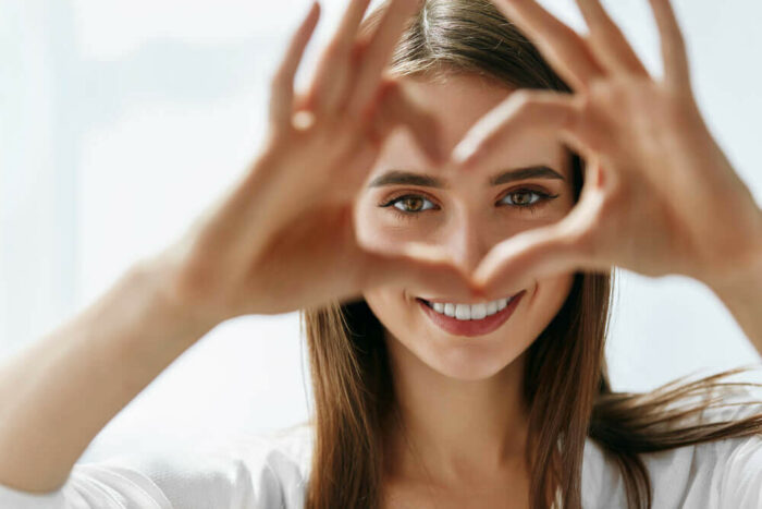 woman making a heart with her hands